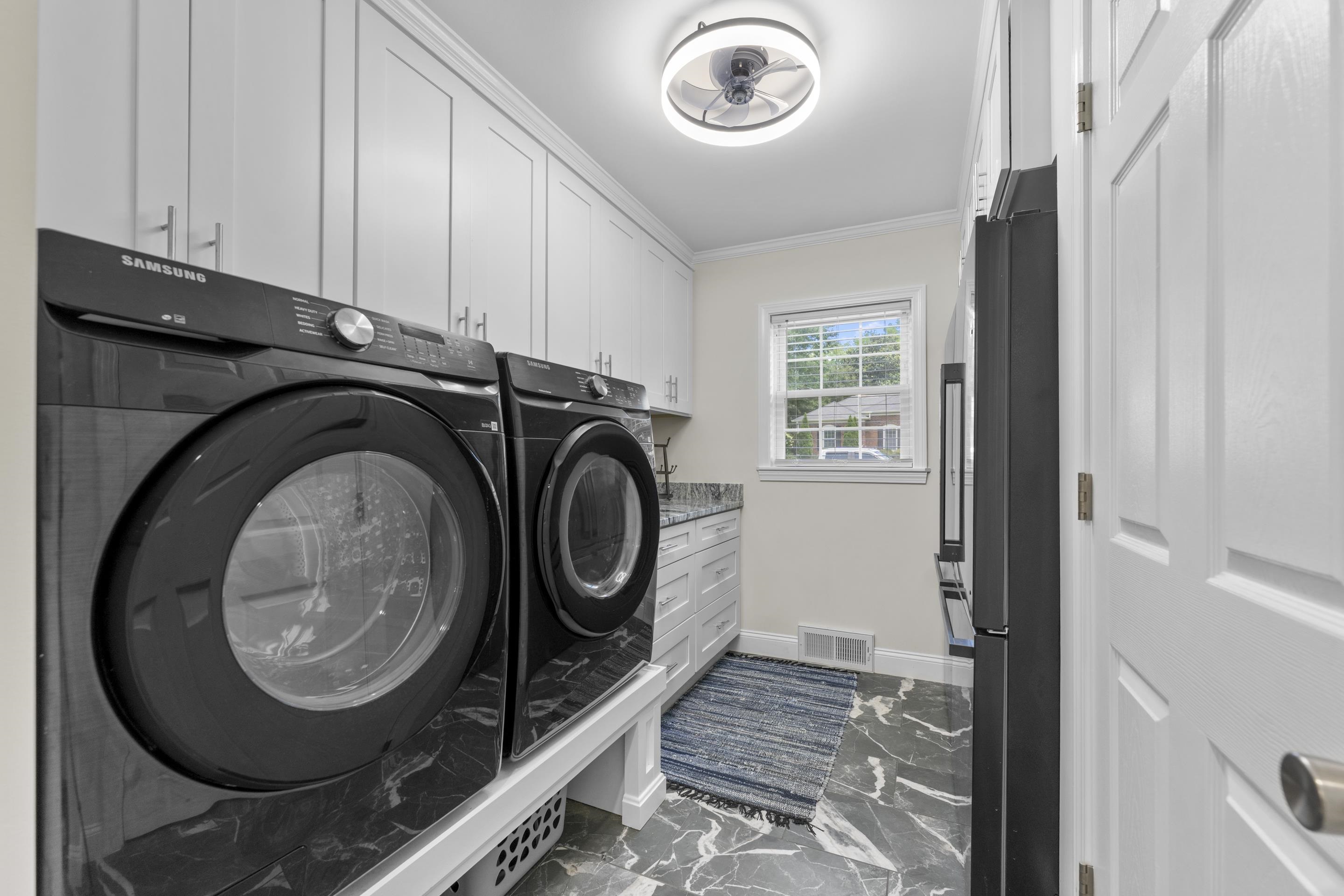 2218 Riverdale Road Germantown, TN 38138 - Photo 16 of 40 Well-appointed laundry room featuring abundant cabinetry, generous counter space, and a window that fills the room with natural light.