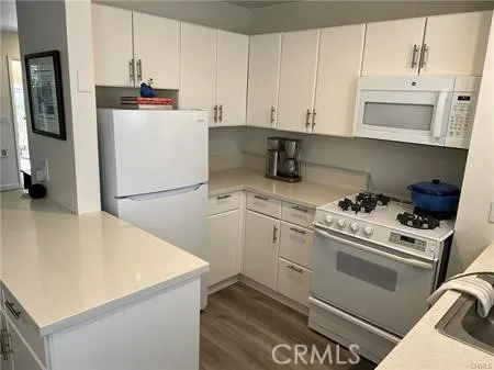 a kitchen with stainless steel appliances white cabinets and a refrigerator