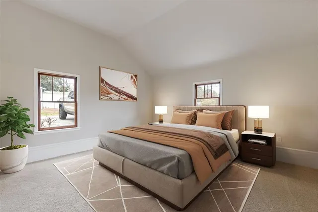 a spacious bedroom with a bed and window