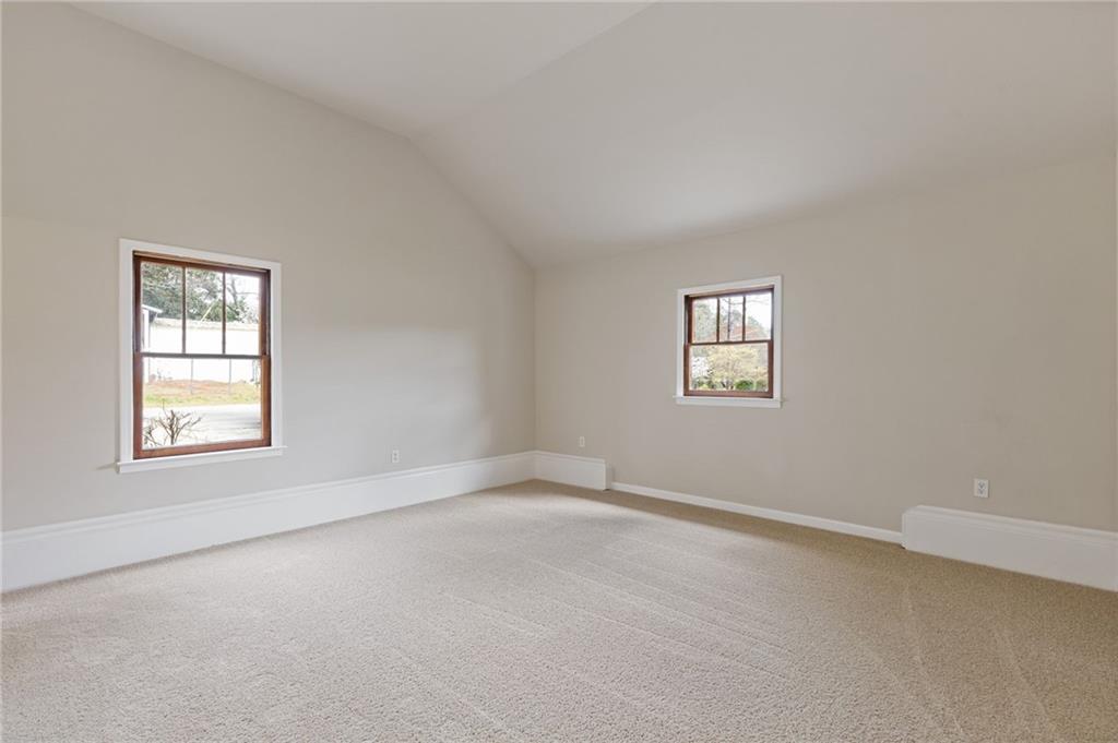 1312 Milstead Avenue Conyers, GA 30012 - Photo 14 of 34 an empty room with windows