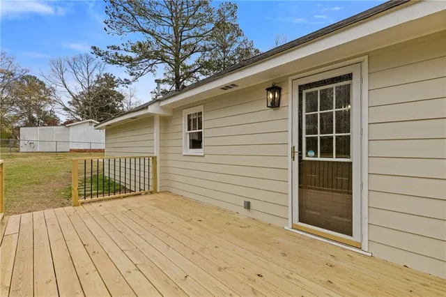 a view of balcony with wooden floor and fence