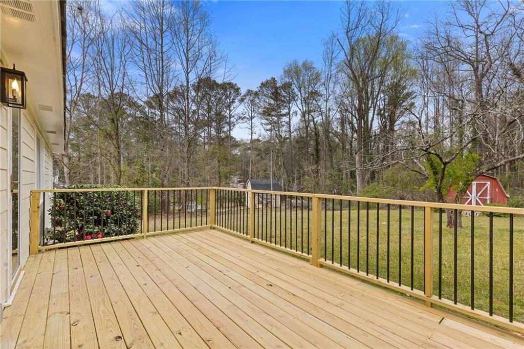 1312 Milstead Avenue Conyers, GA 30012 - Photo 24 of 34 a view of balcony with wooden floor and fence