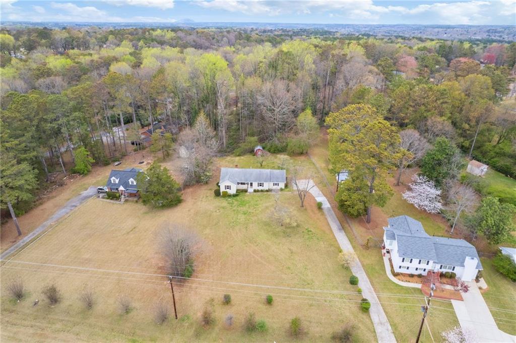 1312 Milstead Avenue Conyers, GA 30012 - Photo 29 of 34 a swimming pool with trees in the background