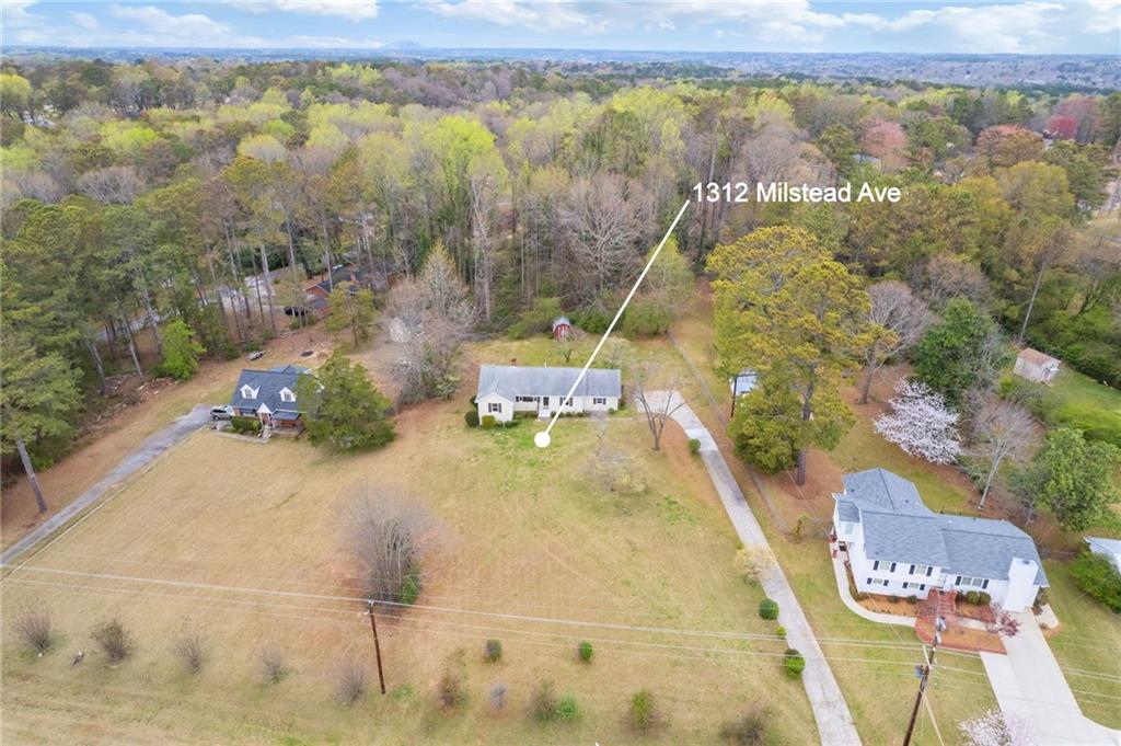 1312 Milstead Avenue Conyers, GA 30012 - Photo 30 of 34 a swimming pool with trees in the background