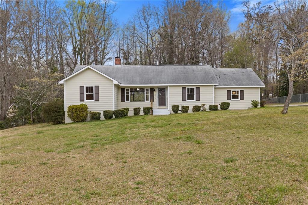1312 Milstead Avenue Conyers, GA 30012 - Photo 3 of 34 a front view of a house with a yard