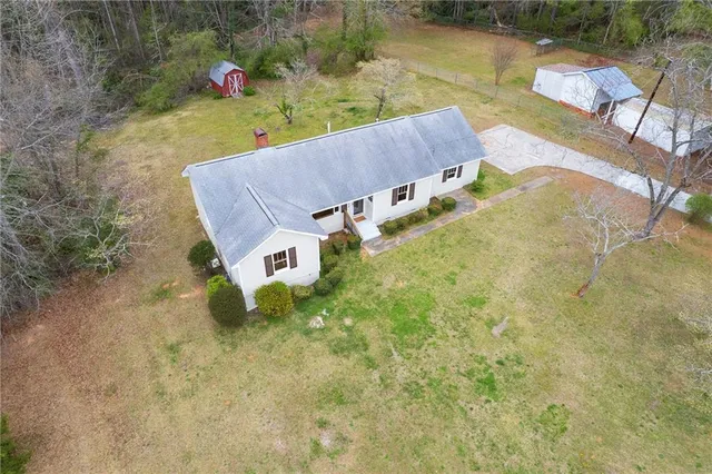 an aerial view of a house with pool
