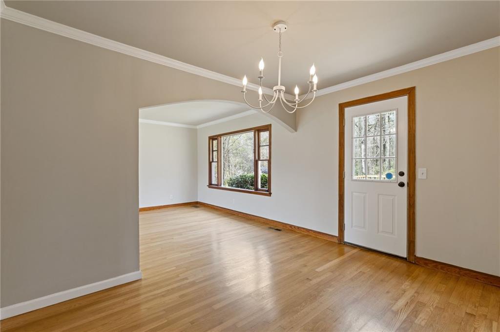 1312 Milstead Avenue Conyers, GA 30012 - Photo 10 of 34 a view of an empty room with wooden floor and a window