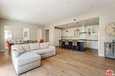 a living room with furniture and kitchen view
