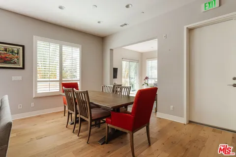 a dining room with furniture and wooden floor