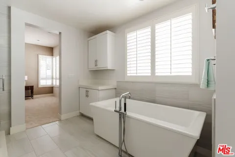 a bathroom with a bathtub and window