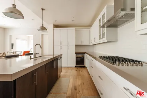 a kitchen with stainless steel appliances granite countertop a sink stove and cabinets