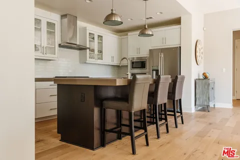 a view of kitchen with cabinets and wooden floor
