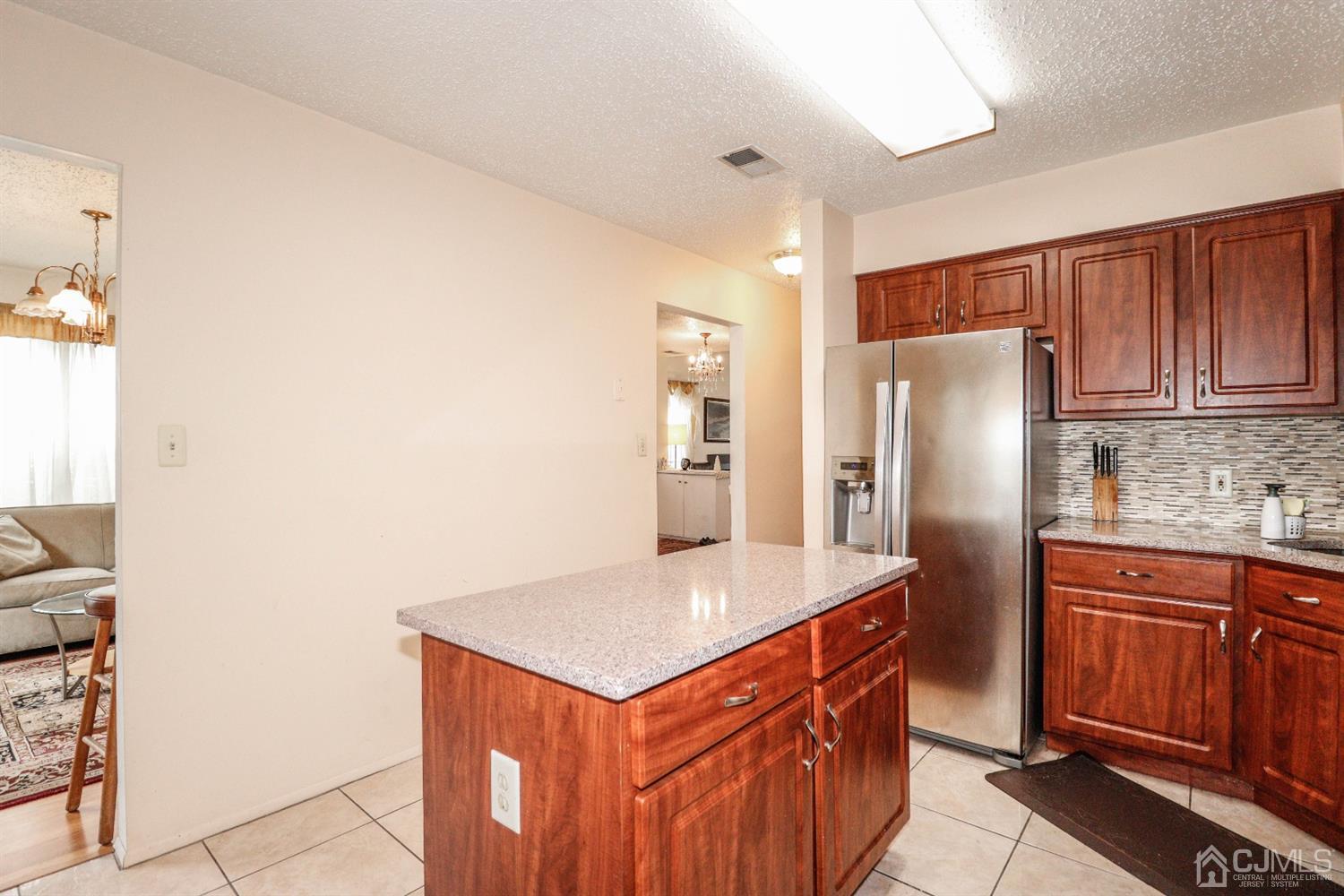 348 Lunar Road Piscataway, NJ 08854 - Photo 13 of 33 a kitchen with stainless steel appliances a refrigerator and wooden cabinets