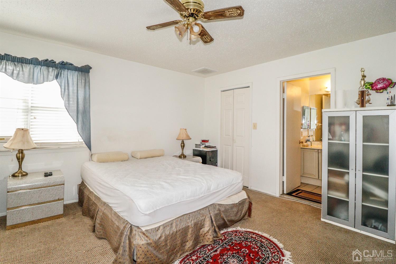 348 Lunar Road Piscataway, NJ 08854 - Photo 16 of 33 a bedroom with a bed and a chandelier