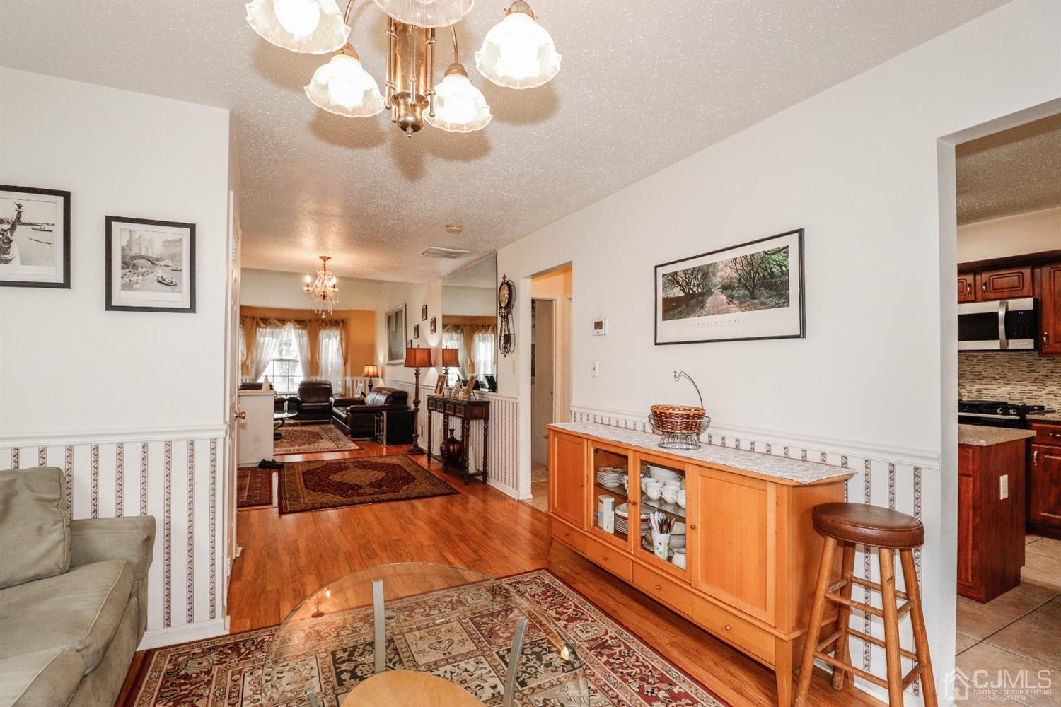 348 Lunar Road Piscataway, NJ 08854 - Photo 6 of 33 a living room with lots of furniture chandelier and a rug