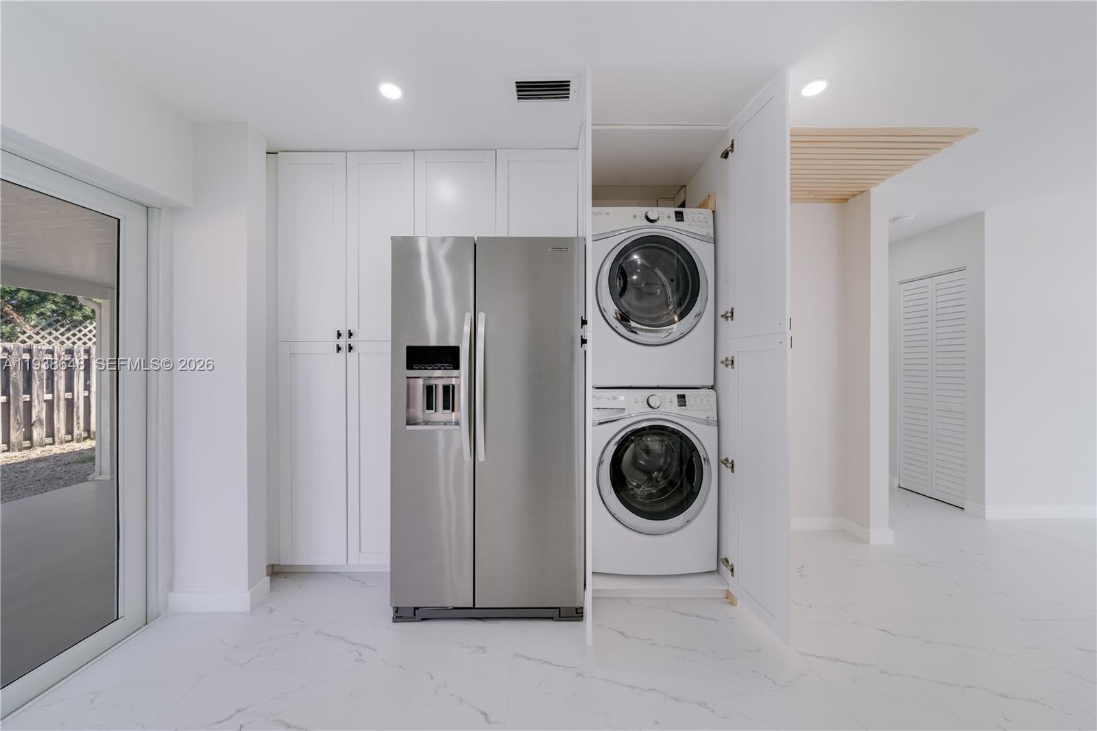 9826 Southwest 222nd Terrace, Unit 9826 Cutler Bay, FL 33190 - Photo 12 of 36 a view of a hallway with washer and dryer