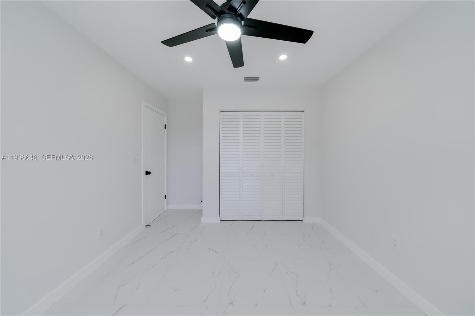 9826 Southwest 222nd Terrace, Unit 9826 Cutler Bay, FL 33190 - Photo 19 of 36 en empty room with ceiling fan