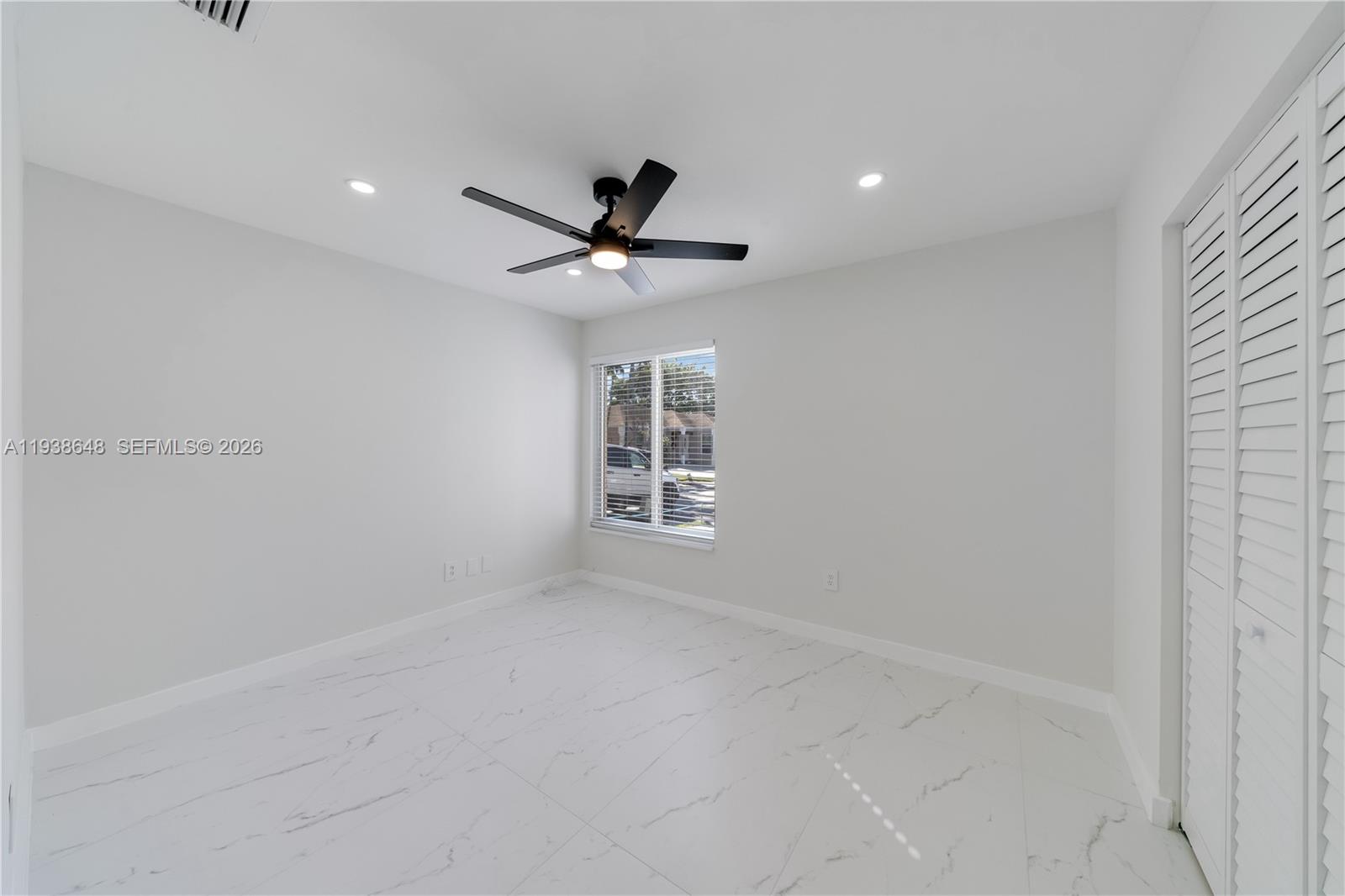 9826 Southwest 222nd Terrace, Unit 9826 Cutler Bay, FL 33190 - Photo 20 of 36 a view of an empty room with a window