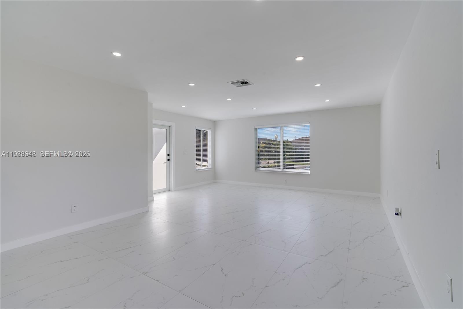 9826 Southwest 222nd Terrace, Unit 9826 Cutler Bay, FL 33190 - Photo 2 of 36 a view of an empty room with a window