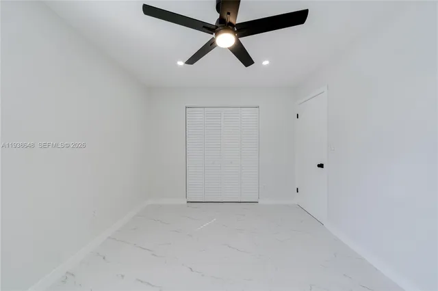 an empty room with ceiling fan