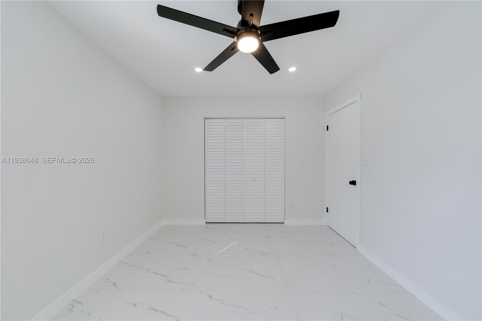 9826 Southwest 222nd Terrace, Unit 9826 Cutler Bay, FL 33190 - Photo 21 of 36 an empty room with ceiling fan
