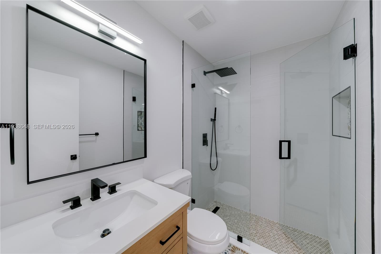 9826 Southwest 222nd Terrace, Unit 9826 Cutler Bay, FL 33190 - Photo 22 of 36 a bathroom with a sink toilet and shower