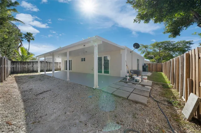 a view of a house with backyard and sitting area