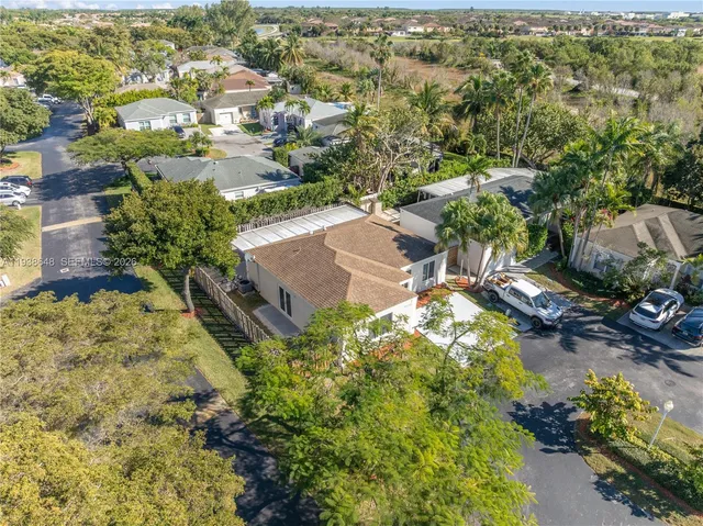 an aerial view of residential houses with outdoor space