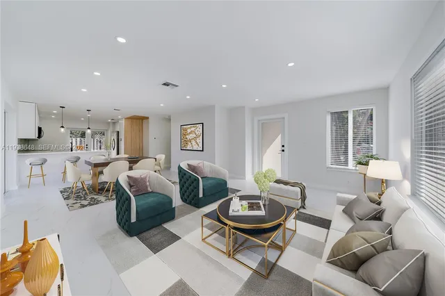 a living room with furniture kitchen and a window