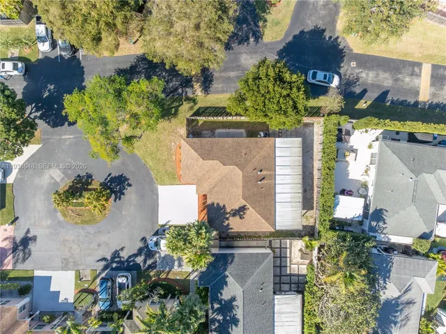an aerial view of a house with a yard and garden