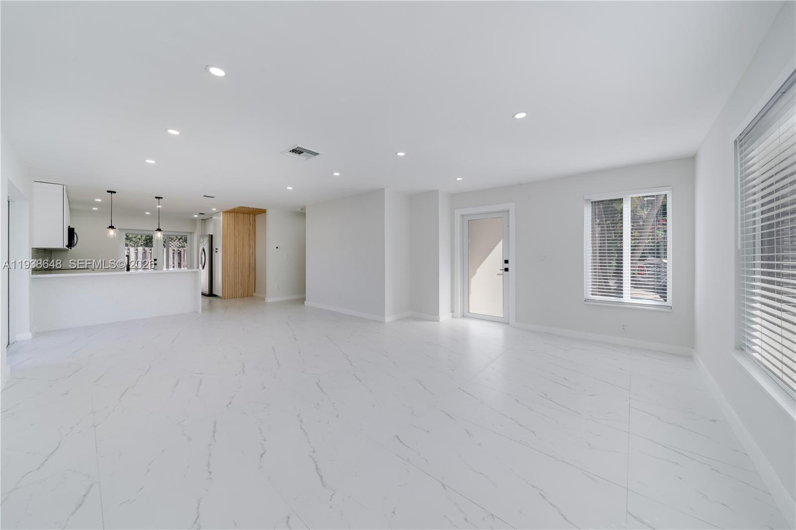 9826 Southwest 222nd Terrace, Unit 9826 Cutler Bay, FL 33190 - Photo 4 of 36 a view of an empty room with a window