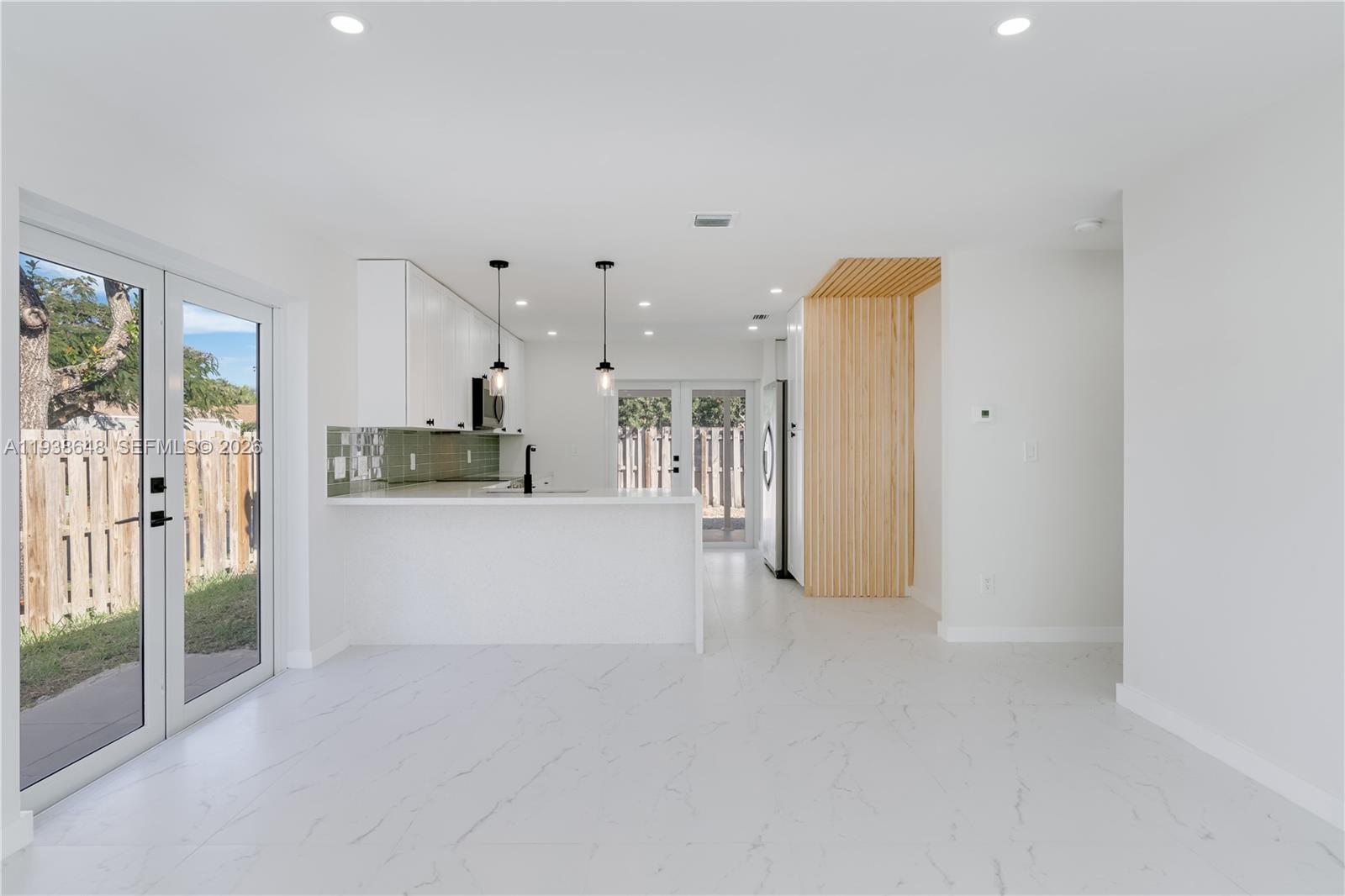 9826 Southwest 222nd Terrace, Unit 9826 Cutler Bay, FL 33190 - Photo 7 of 36 a view of a kitchen with refrigerator and windows
