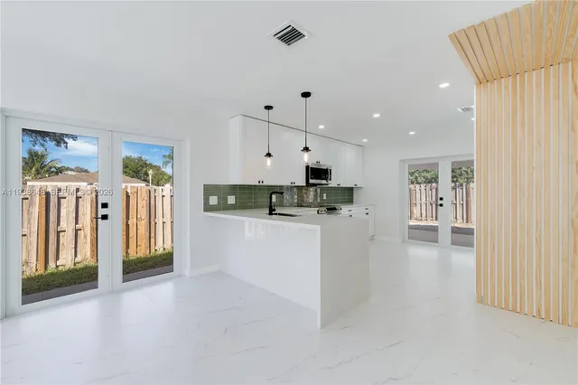 a view of kitchen with stainless steel appliances refrigerator oven