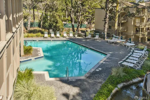 a view of a house with backyard sitting area and garden