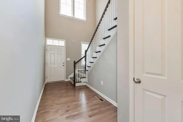a view of entryway with wooden floor and stairs