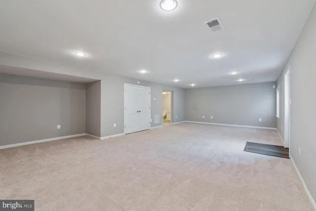 a view of a hallway with wooden floor and stairs