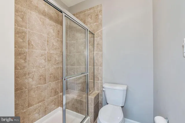 a bathroom with a toilet and a shower