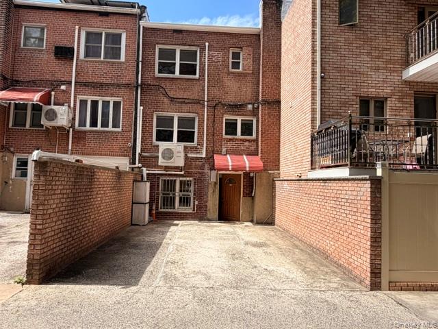 150-06 78th Road Queens, NY 11367 - Photo 20 of 22 a view of a house with a barbeque and wooden stairs