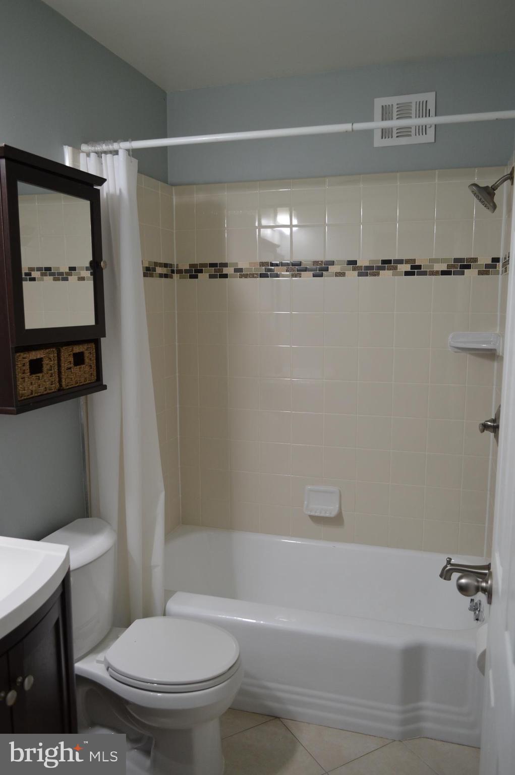 10110 Portland Road Silver Spring, MD 20901 - Photo 21 of 39 Remodeled hall bath with designer tile