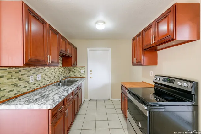 a kitchen that has a sink and a stove