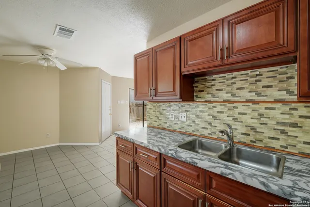 a kitchen with stainless steel appliances granite countertop a sink and cabinets