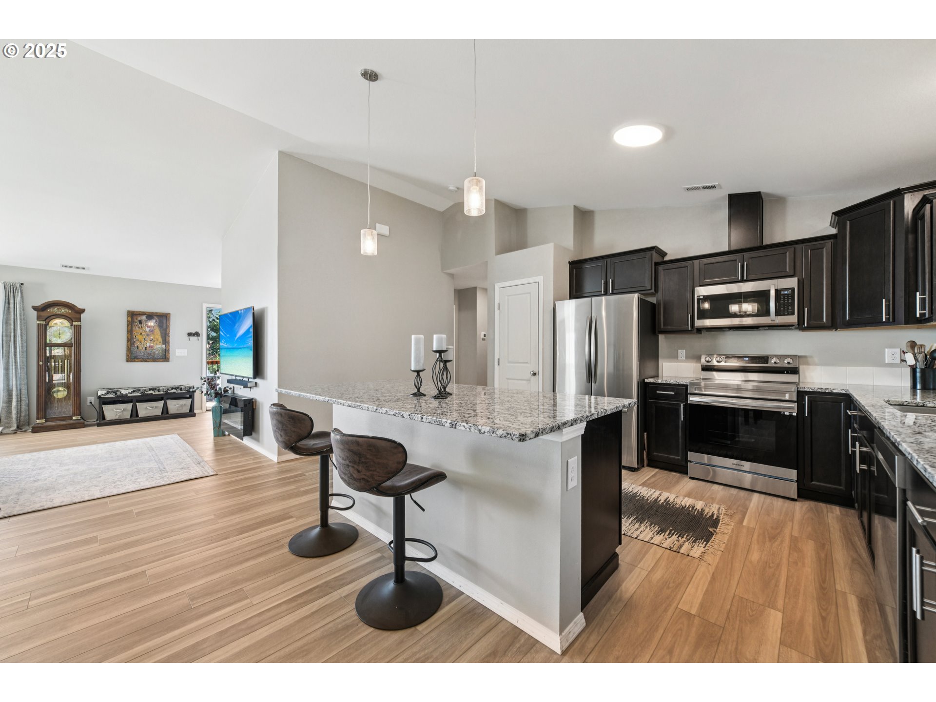 9 Curtis Lane Longview, WA 98632 - Photo 13 of 37 a kitchen with stainless steel appliances kitchen island granite countertop a refrigerator stove microwave and sink
