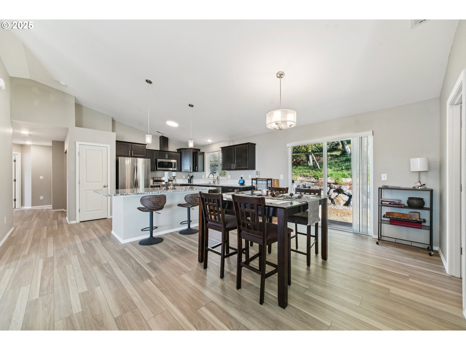 9 Curtis Lane Longview, WA 98632 - Photo 10 of 37 a open kitchen with stainless steel appliances refrigerator dining table and chairs