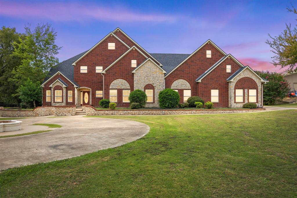 a front view of house with yard and green space