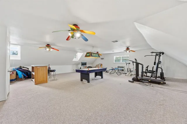 a living room with furniture and a gym equipment