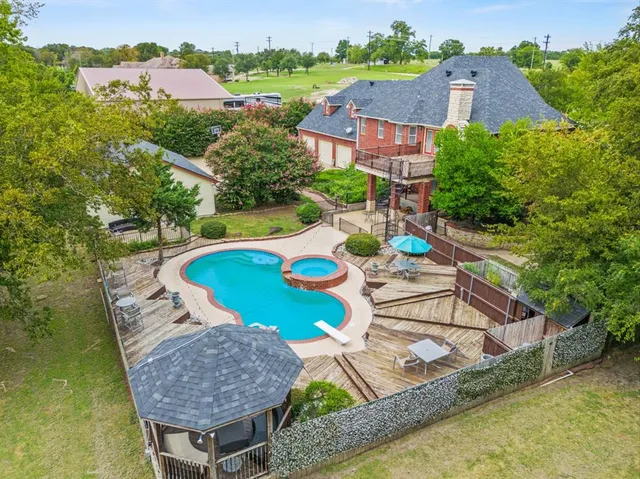 an aerial view of a house having swimming pool