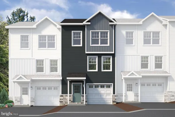 a front view of a residential apartment building with a yard
