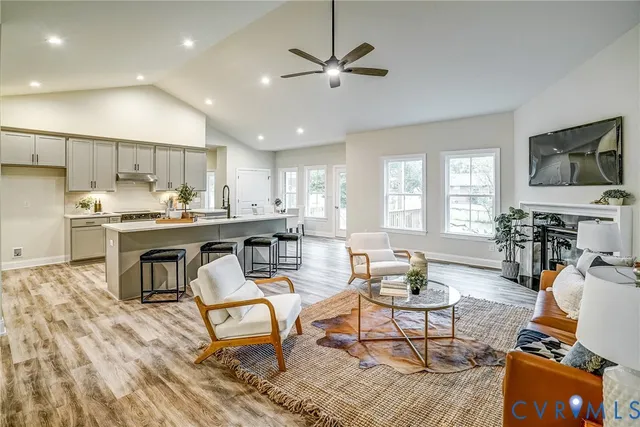 a living room with fireplace furniture and a wooden floor