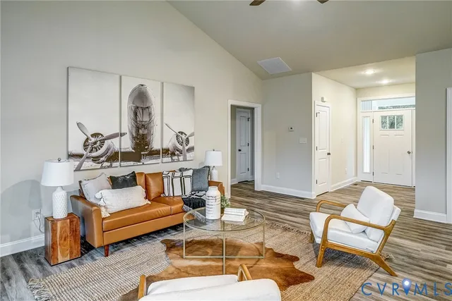a living room with stainless steel appliances kitchen island granite countertop furniture and a dining table