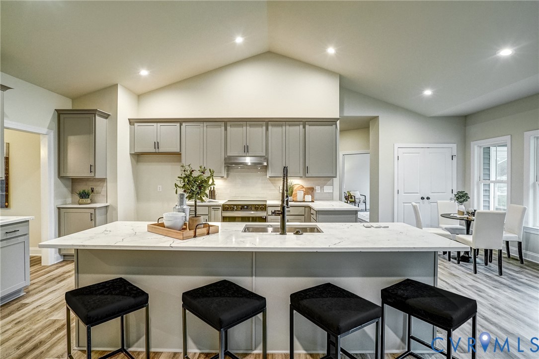 2301 Larkwood Road Henrico, VA 23294 - Photo 19 of 23 a kitchen with stainless steel appliances a dining table chairs and wooden cabinets